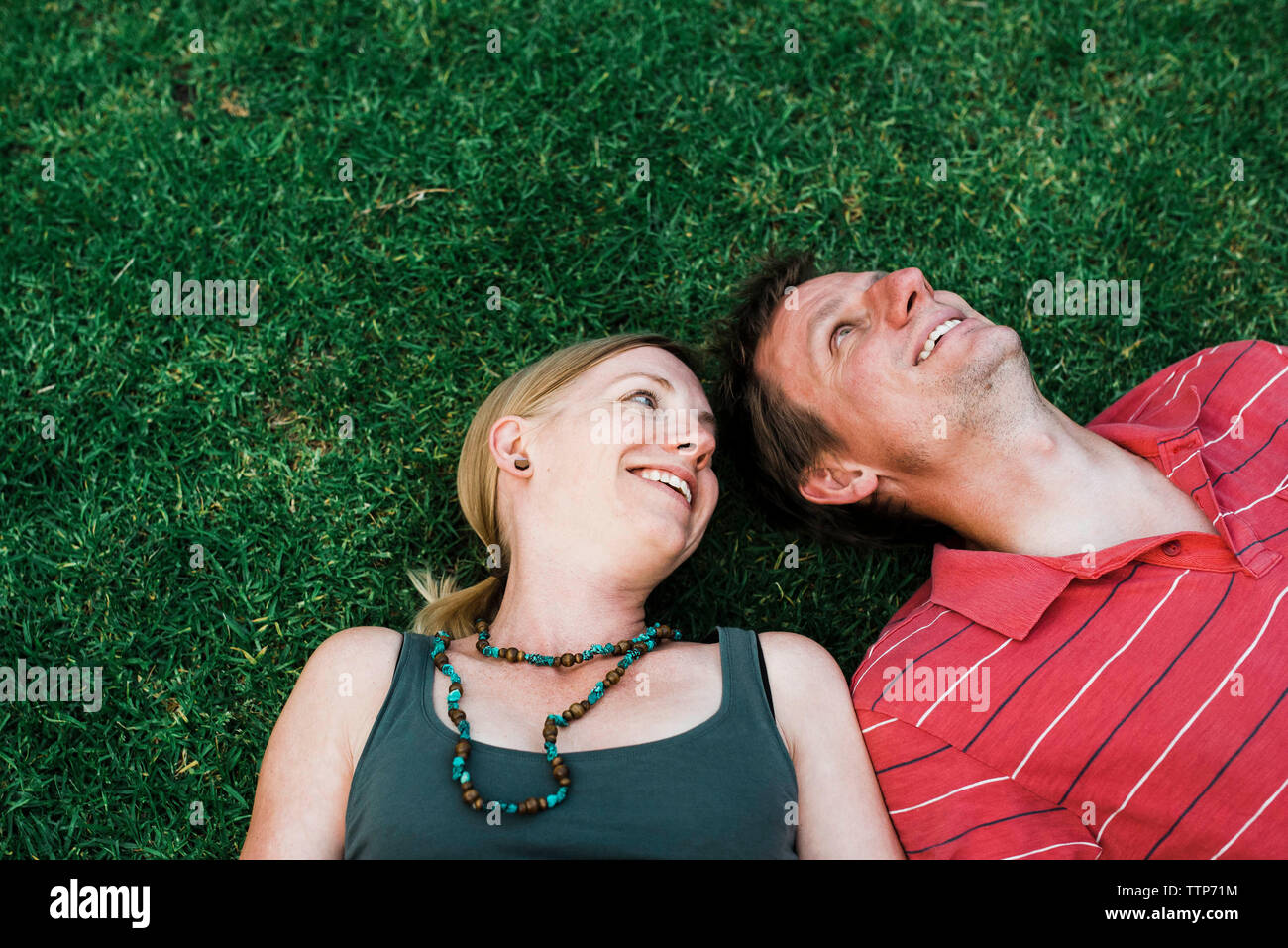 Mature couple lying on grass hi-res stock photography and images - Alamy