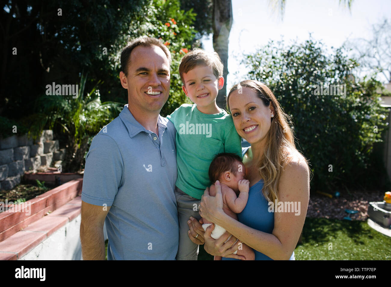 Portrait of happy parents with children standing at yard Stock Photo