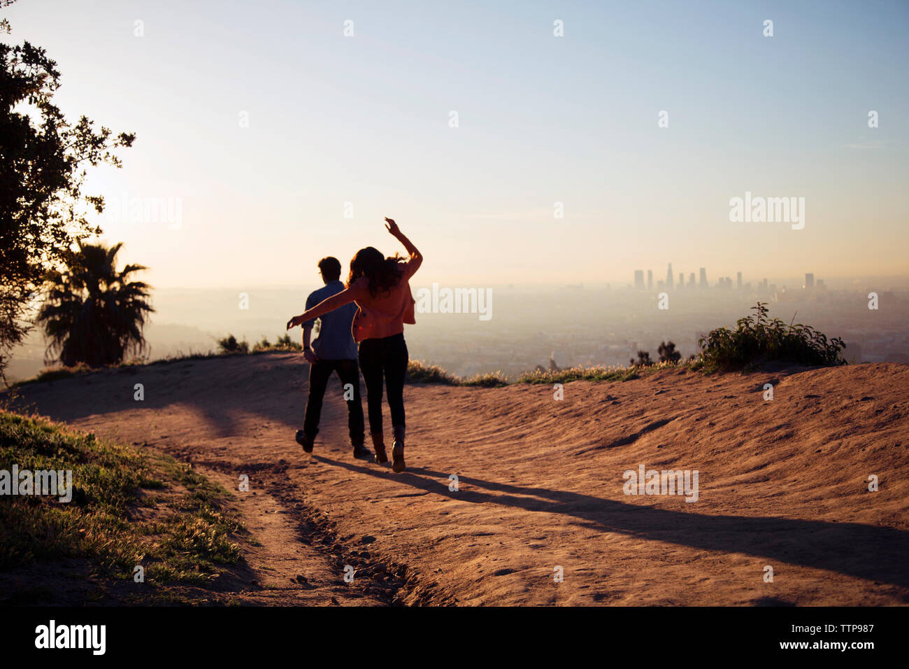 Rear young couple walking city hi-res stock photography and images - Alamy
