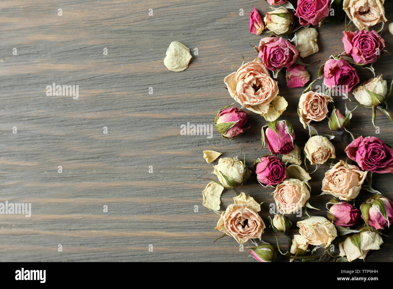 Dried rose buds on wooden background Stock Photo - Alamy