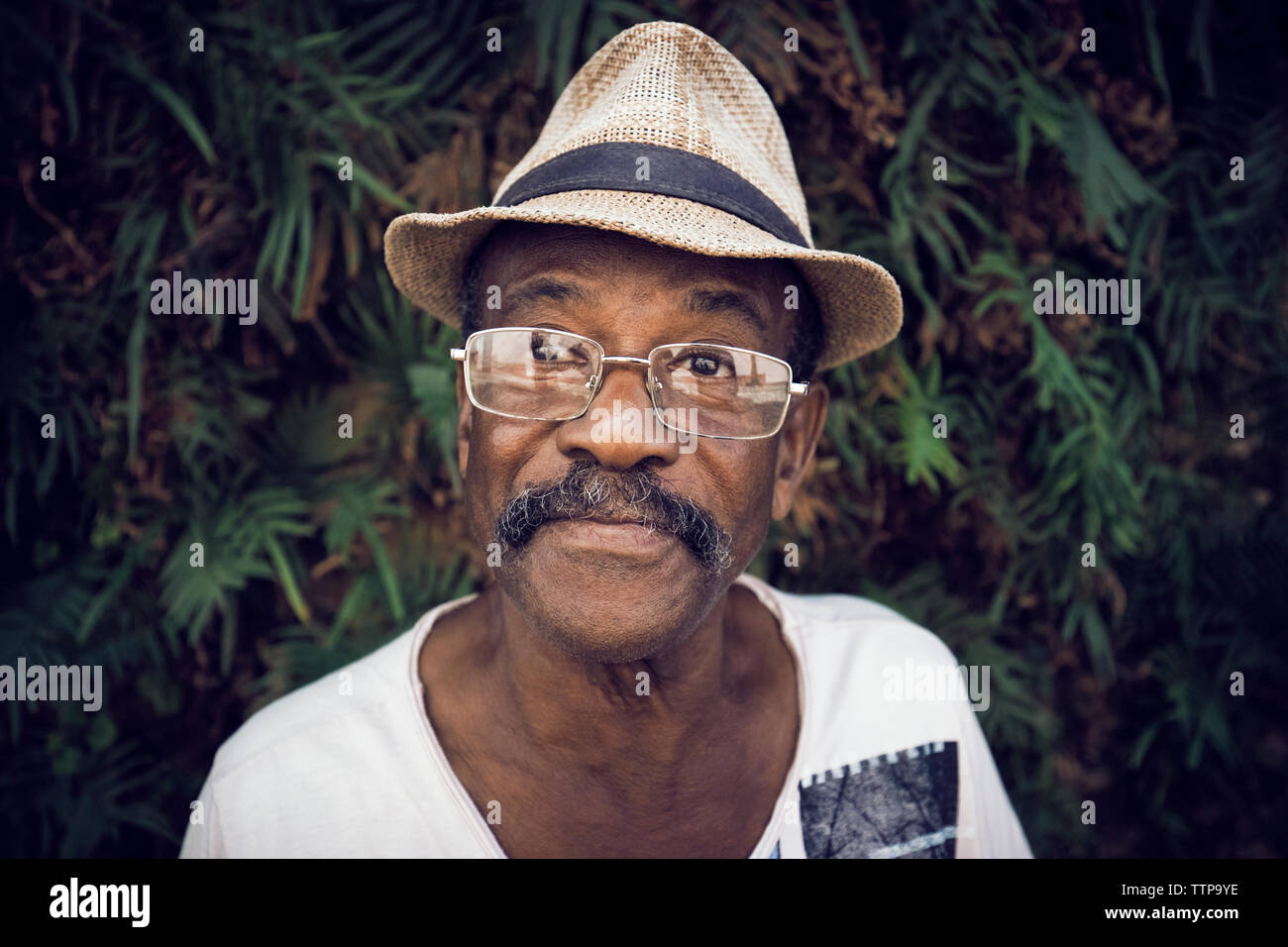 Portrait of man wearing hat against stone wall Stock Photo
