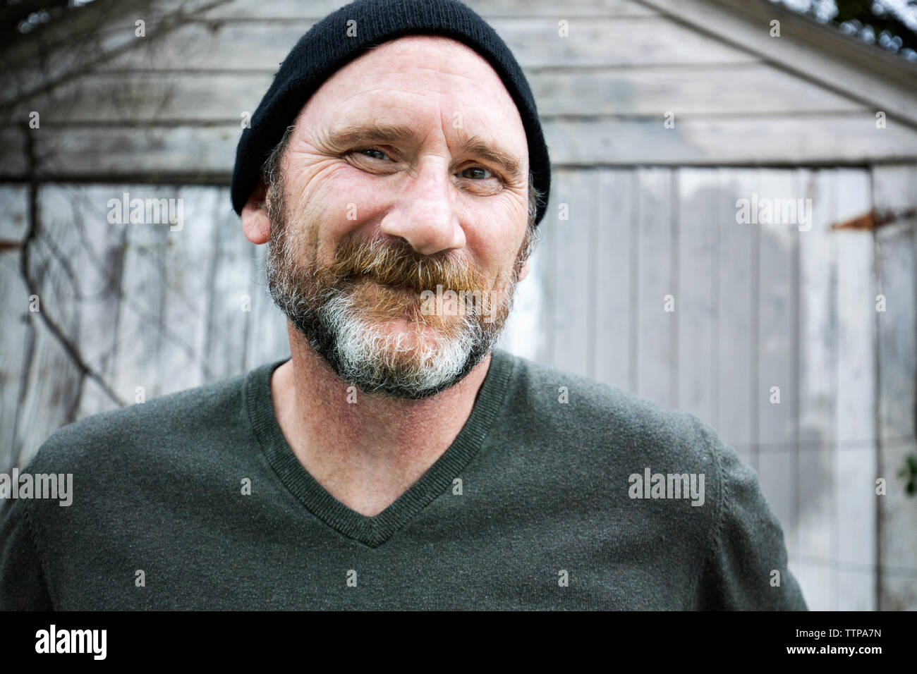 Close-up portrait of smiling man wearing knit hat Stock Photo