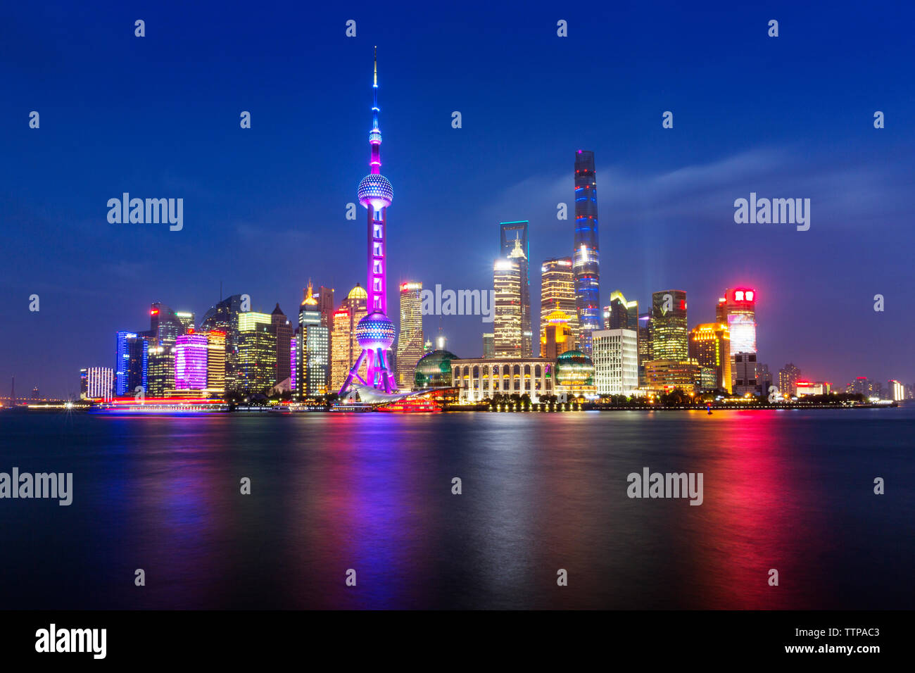 Scenic view of river and illuminated cityscape against sky Stock Photo