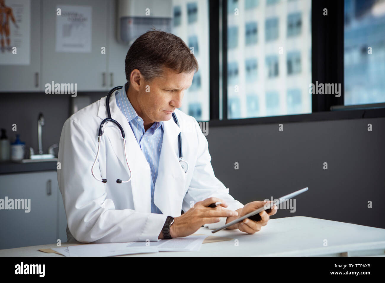 Male doctor using tablet computer in clinic Stock Photo