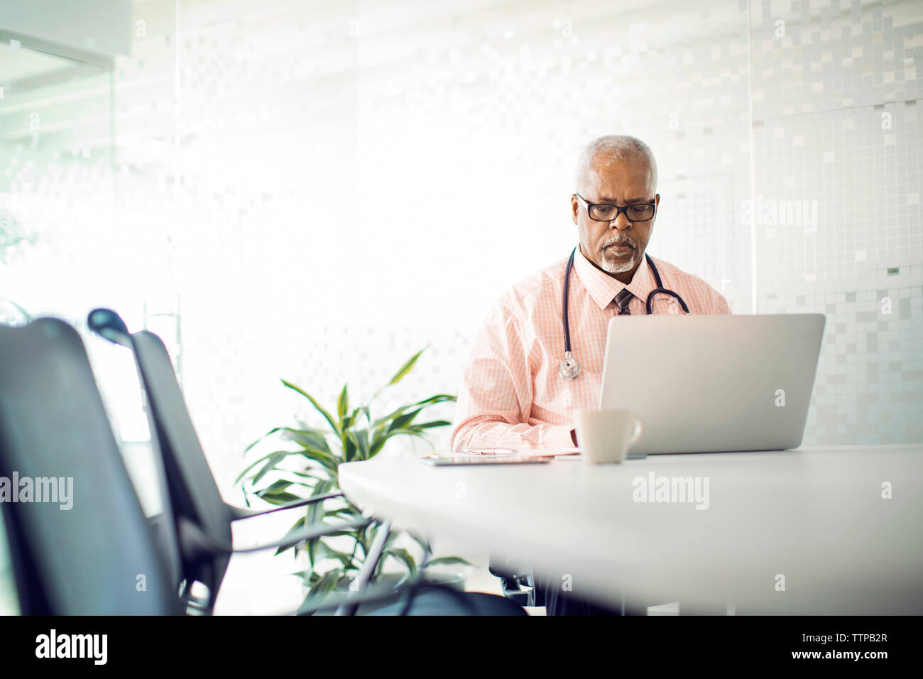 Doctor working on laptop computer in hospital Stock Photo Alamy