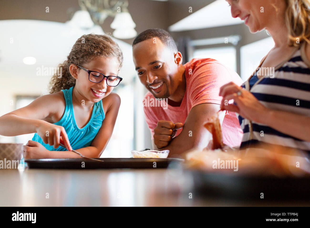 Happy family preparing pizza at home Stock Photo