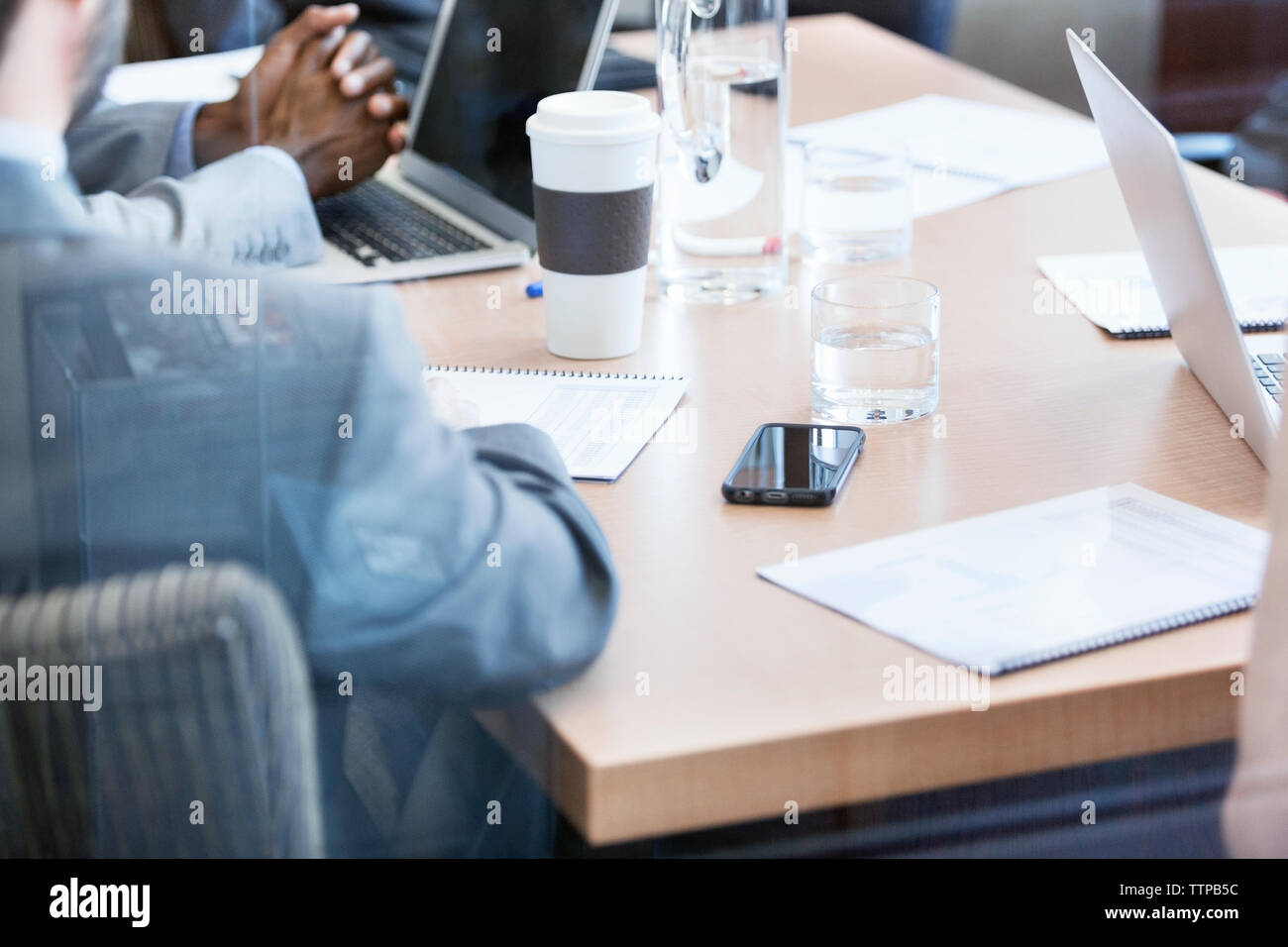 High angle view of business people discussing on desk in office Stock Photo