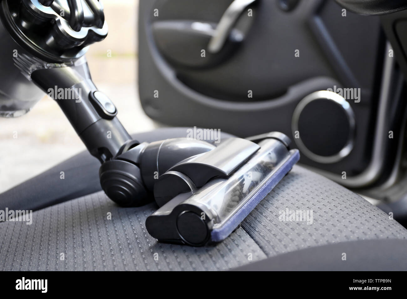 Cleaning the car seat with vacuum cleaner Stock Photo Alamy