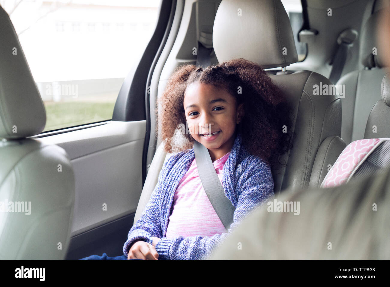 Portrait of happy girl sitting in car Stock Photo - Alamy