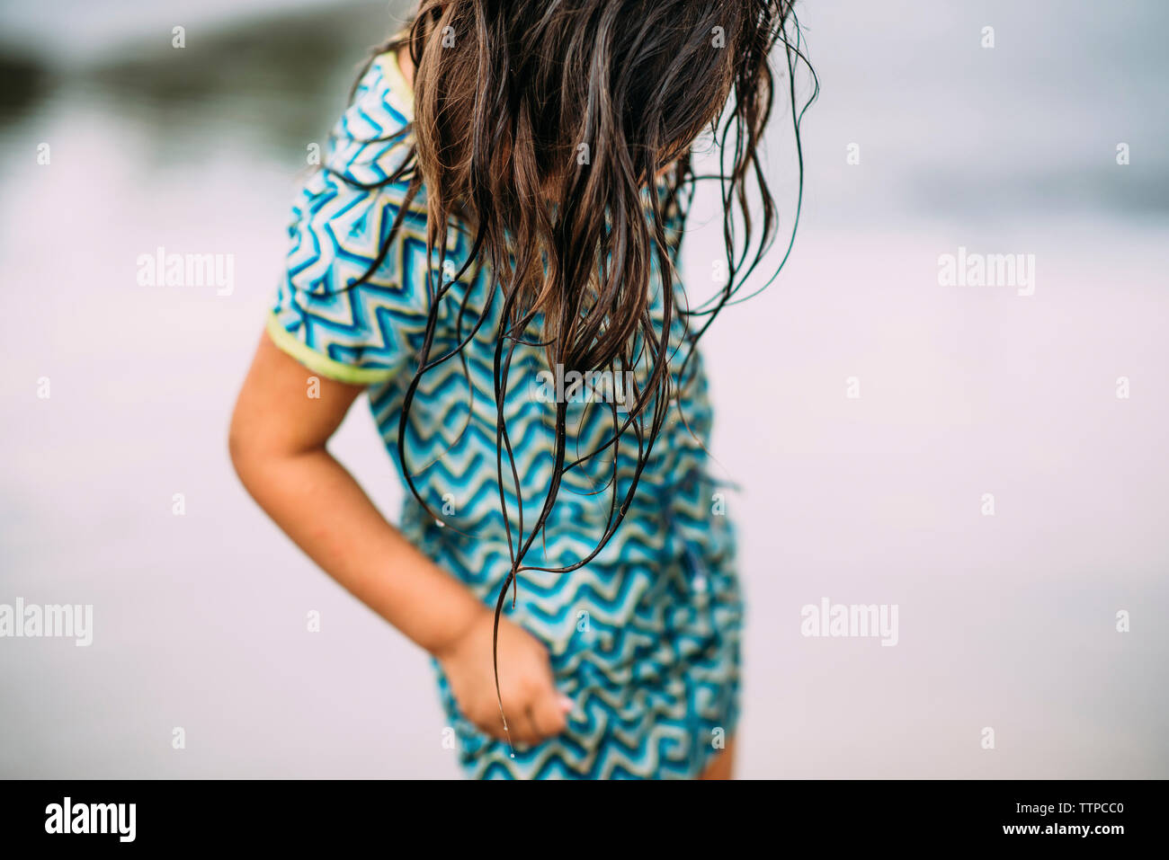 Midsection of girl standing outdoors Stock Photo