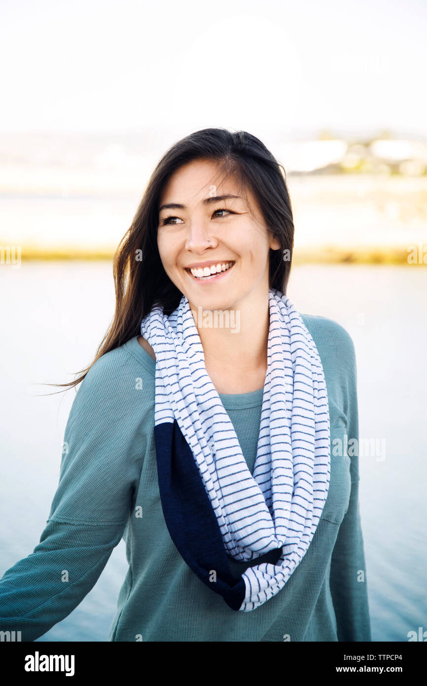 Happy woman standing on beach Stock Photo - Alamy