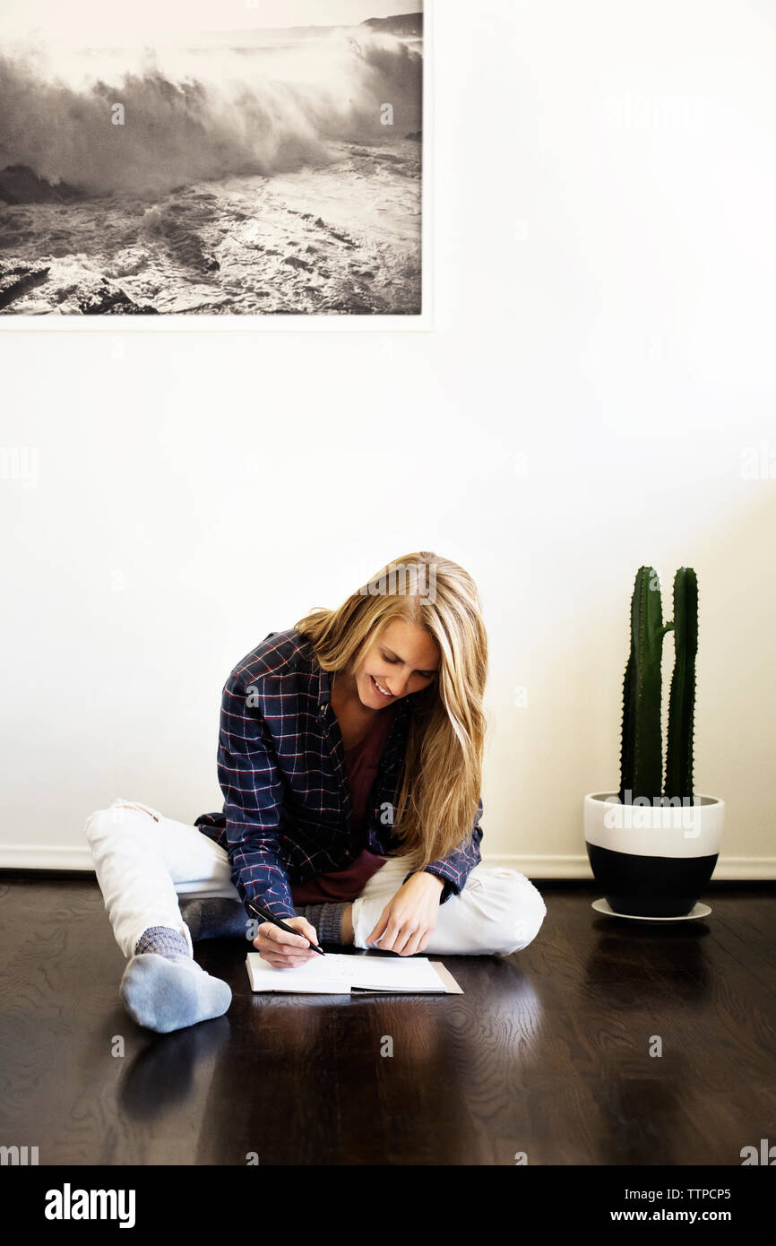 Young woman sitting floor home hi-res stock photography and images - Alamy