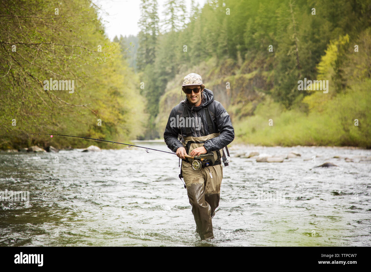 Man walking fishing rod on hi-res stock photography and images - Alamy