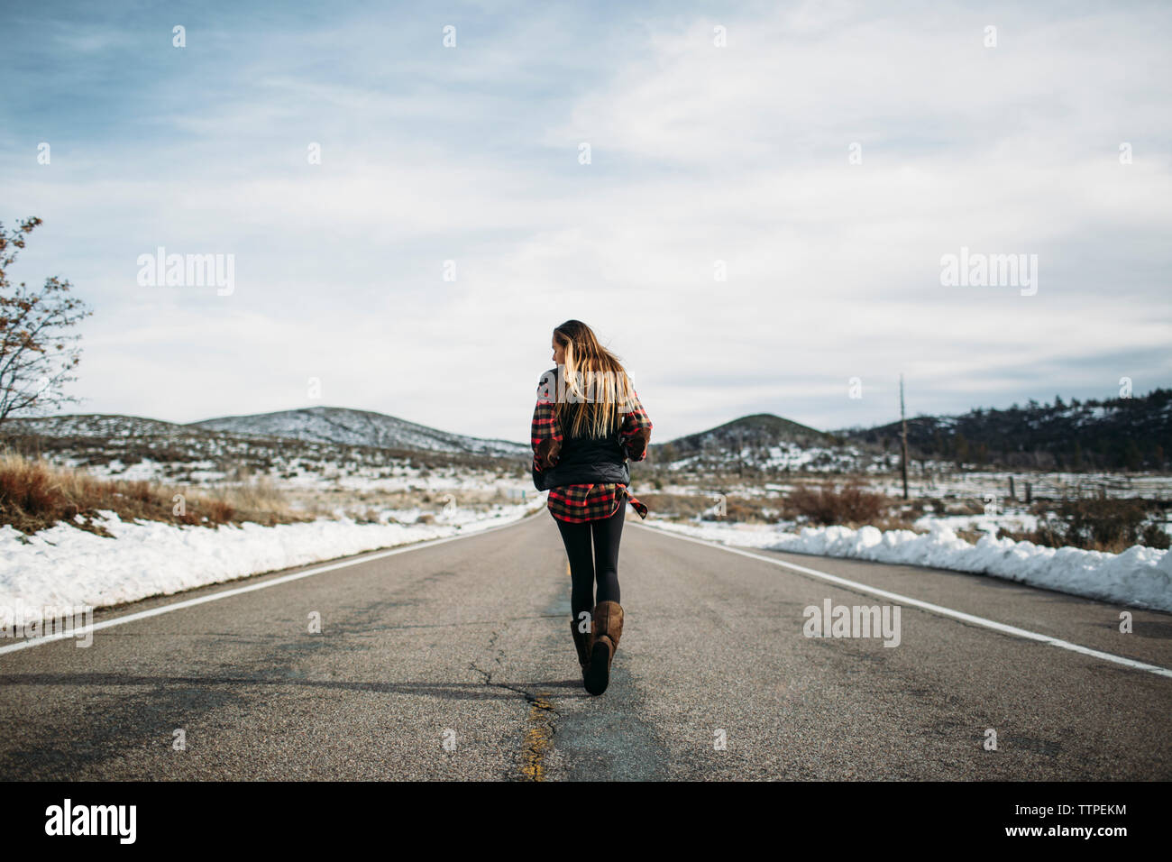 Woman walking rear view road hi-res stock photography and images - Alamy