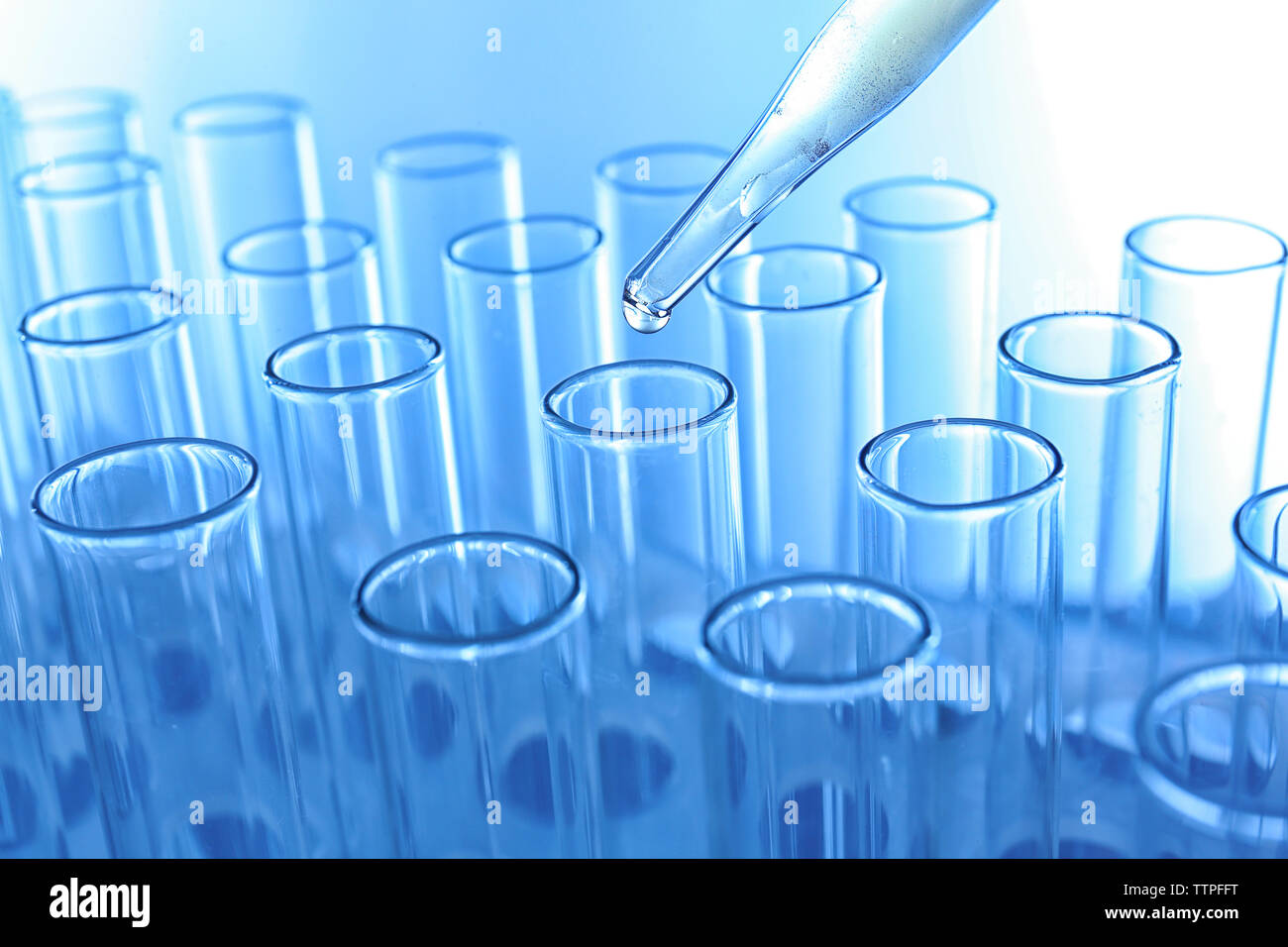 Close up of a pipette dropping sample into a test tube Stock Photo - Alamy