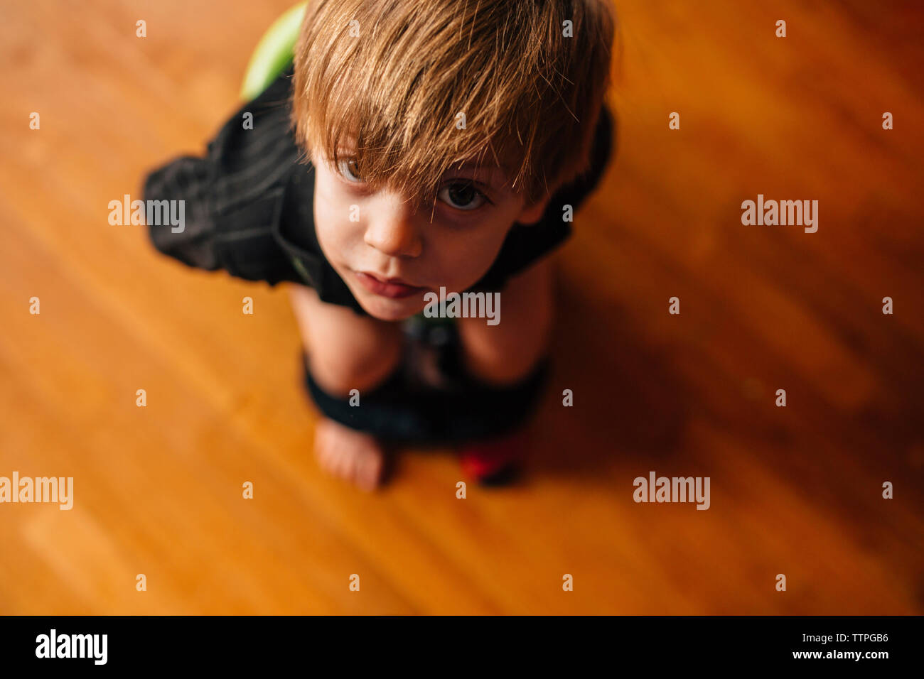 High angle view of boy sitting on baby toilet seat Stock Photo