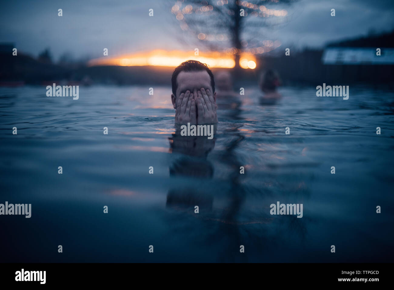 Man Covering His Eyes In The Water At The Secret Lagoon In Iceland Stock Photo Alamy