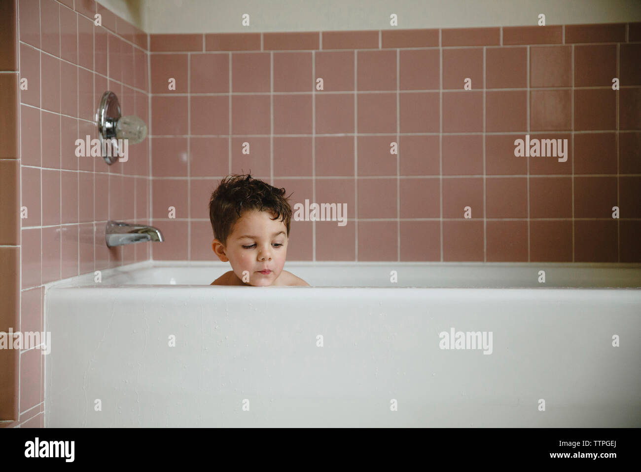 Boy in bathtub at home Stock Photo