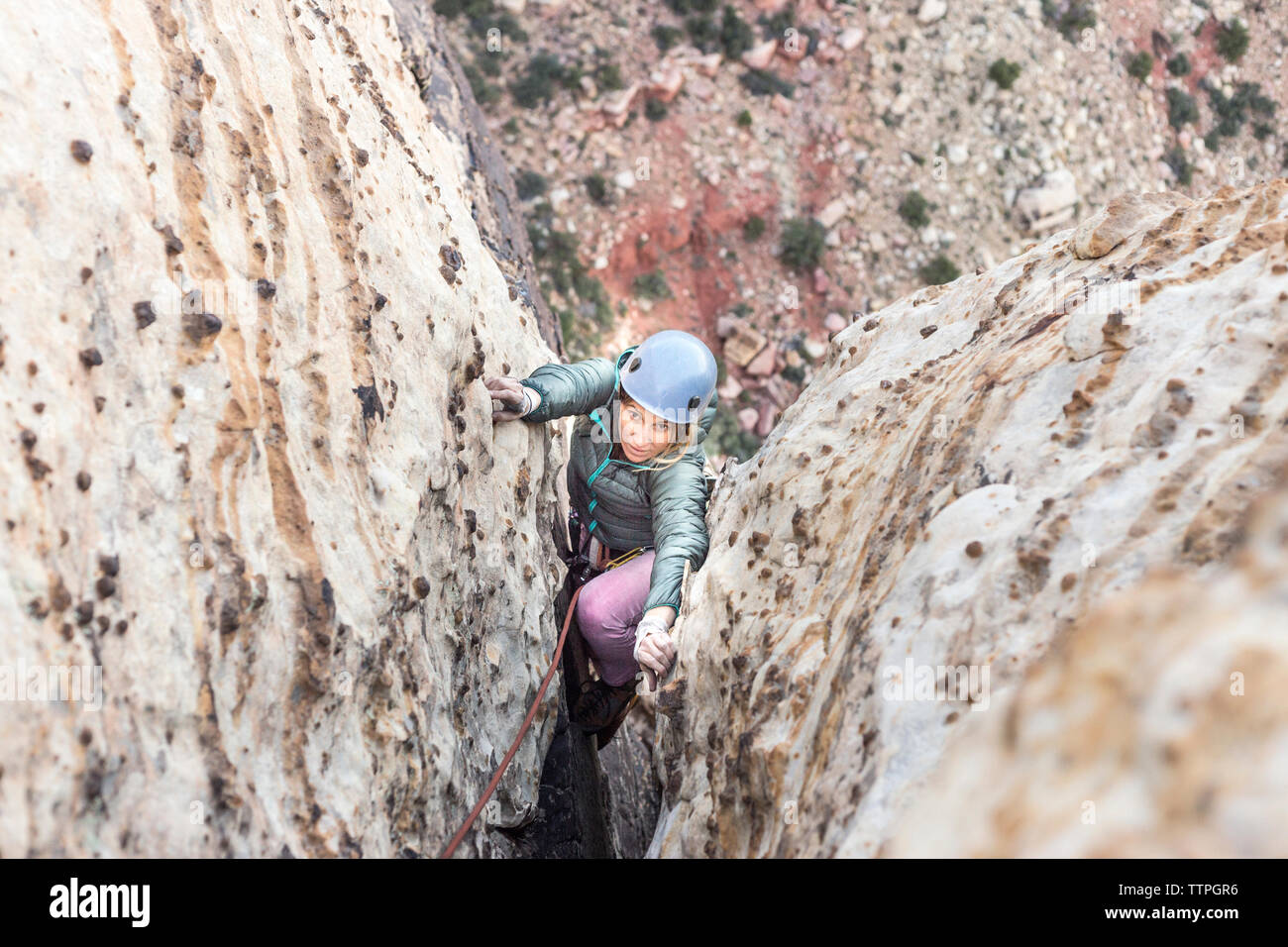 Woman high rock climbing mountain hi-res stock photography and images