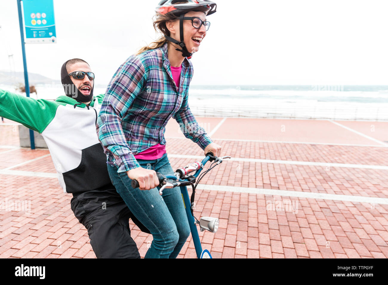 Friends enjoying bicycle ride on promenade Stock Photo