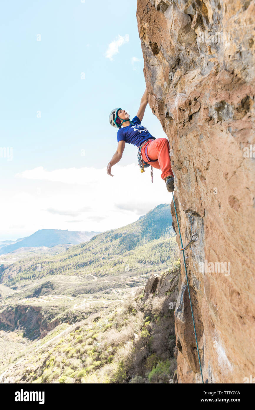 Hiker wearing helmet while climbing mountain Stock Photo Alamy