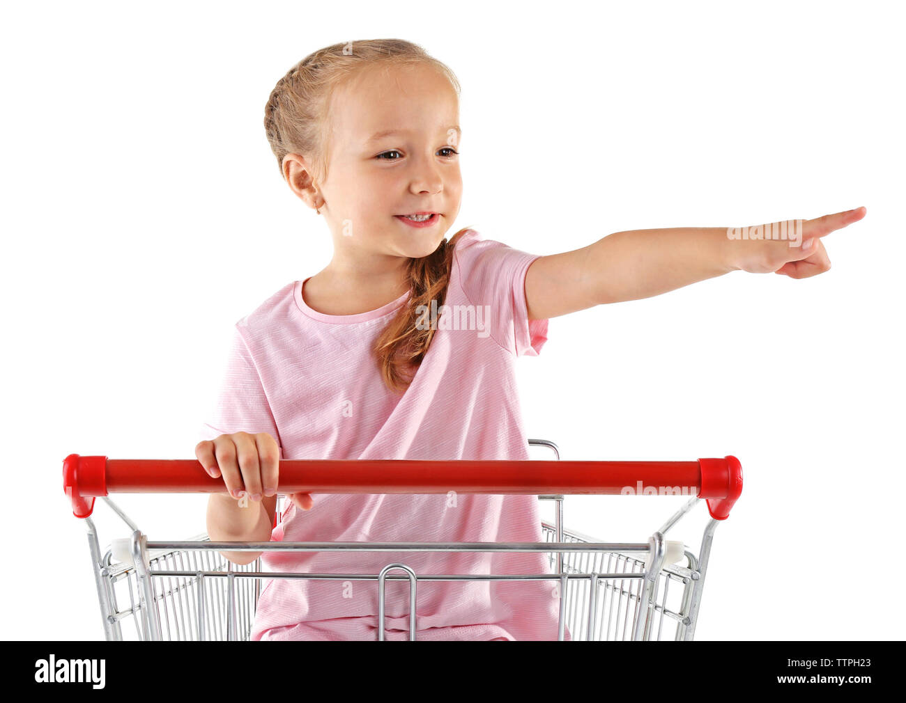 Cute girl sitting in shopping cart on white background Stock Photo - Alamy