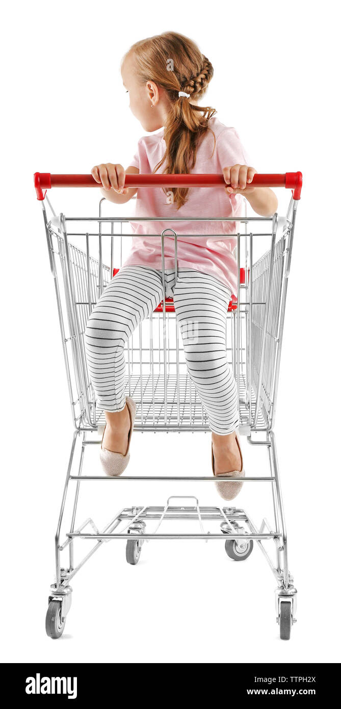 Cute girl sitting in shopping cart on white background Stock Photo - Alamy