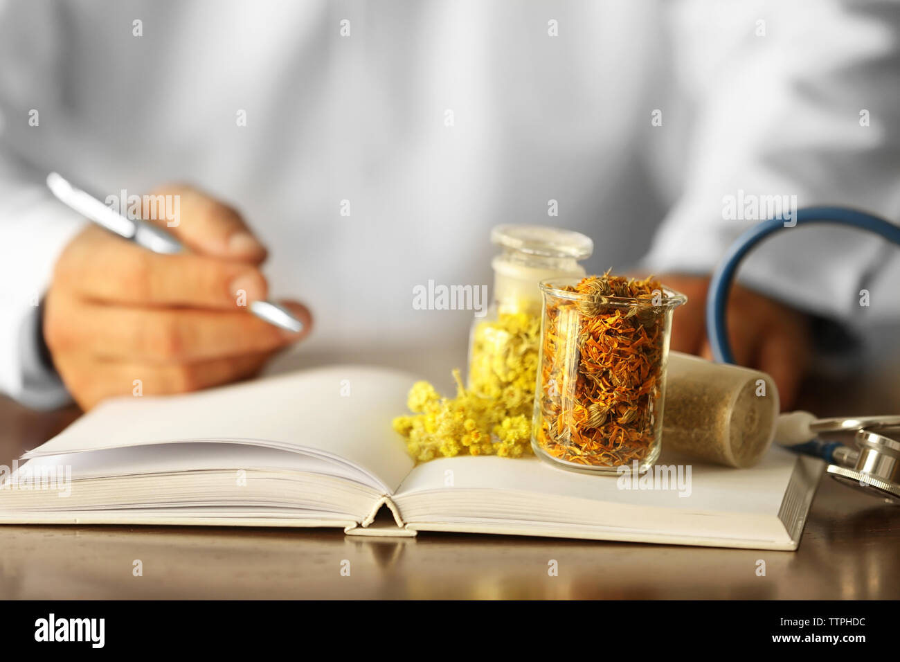 Male doctor with medical recipe book. Herbal medicine concept Stock Photo