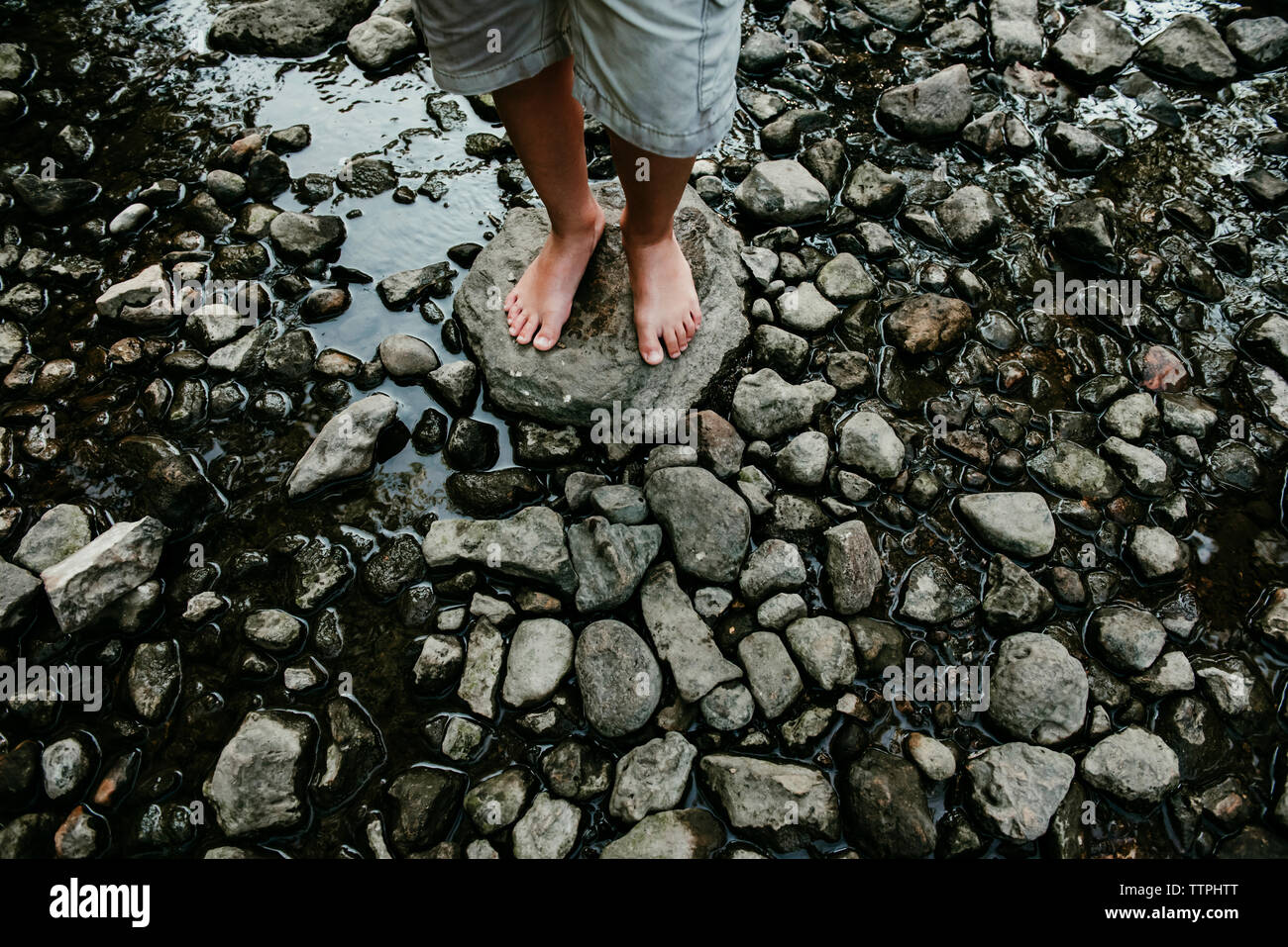 Standing on low rocks hi-res stock photography and images - Alamy