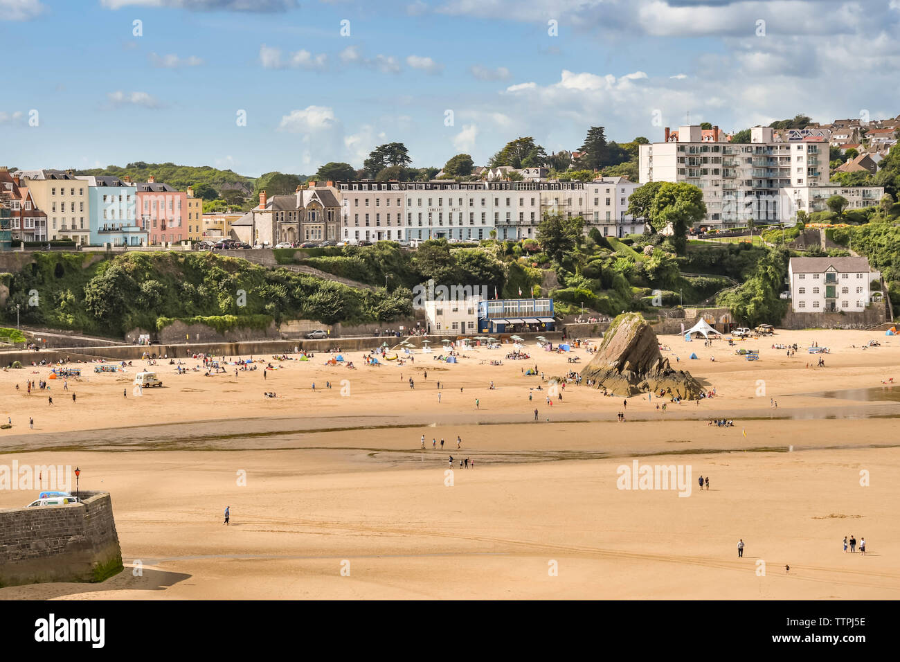TENBY, PEMBROKESHIRE, WALES - AUGUST 2018: People on the South Beach in Tenby, West Wales, at low tide. Stock Photo