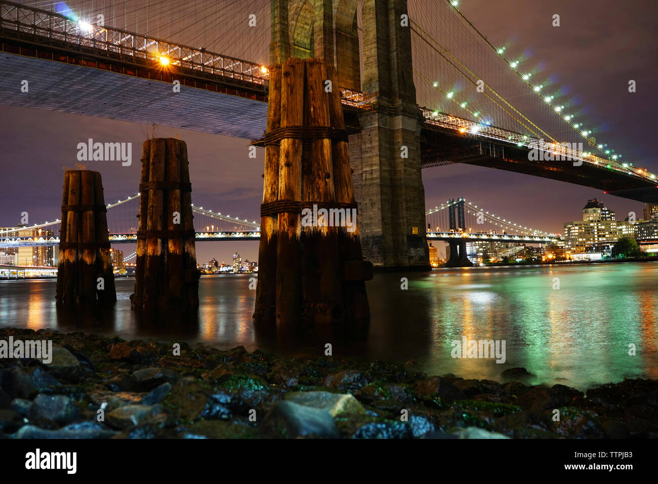 Illuminated bridges over East river at night Stock Photo