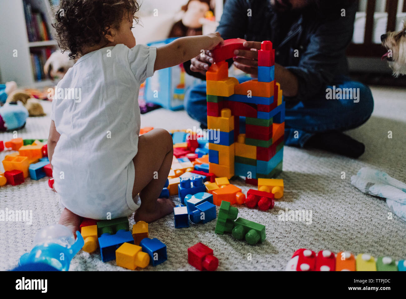 Child and father building block castle Stock Photo