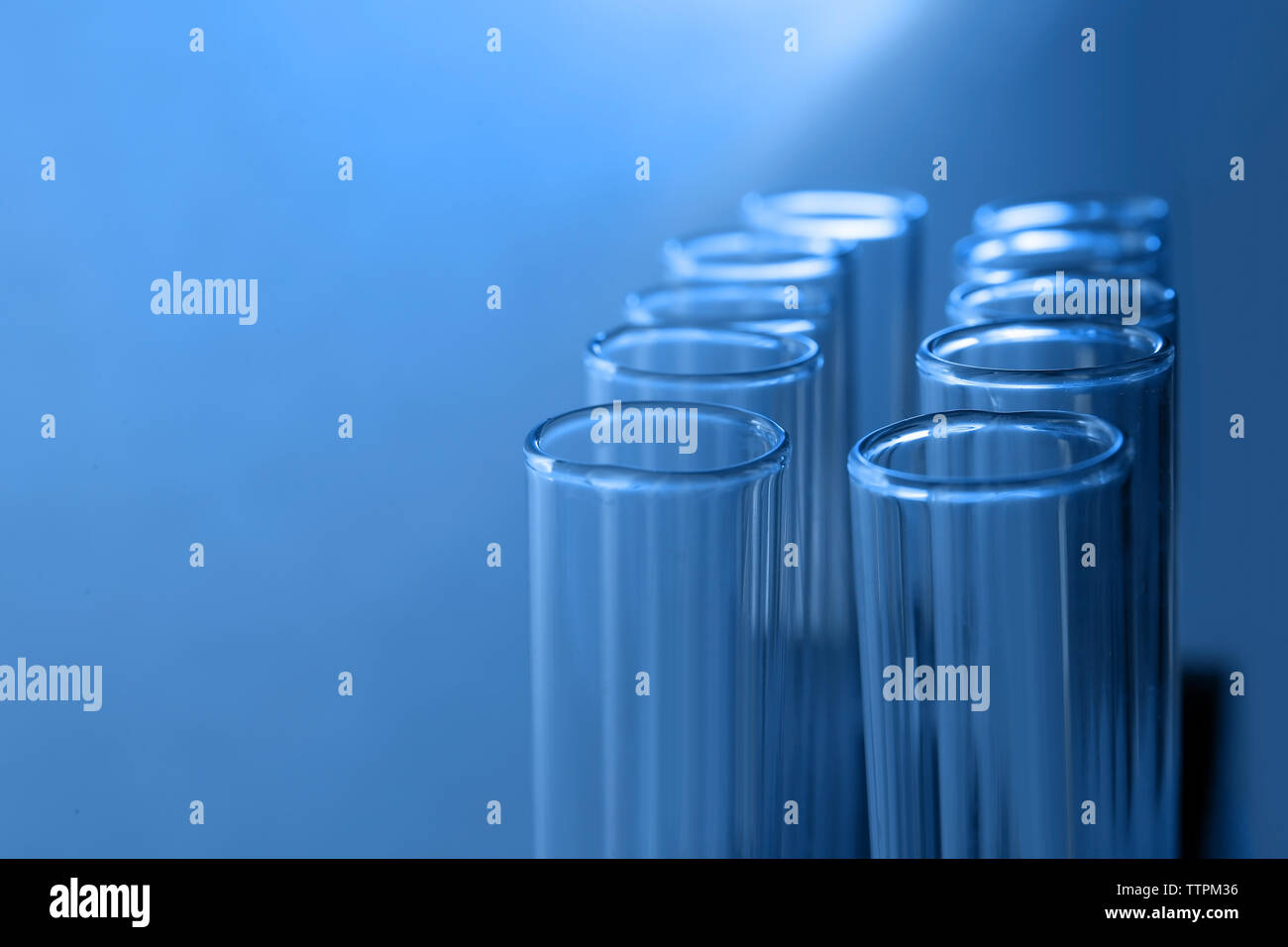 Test tubes on blue background Stock Photo - Alamy