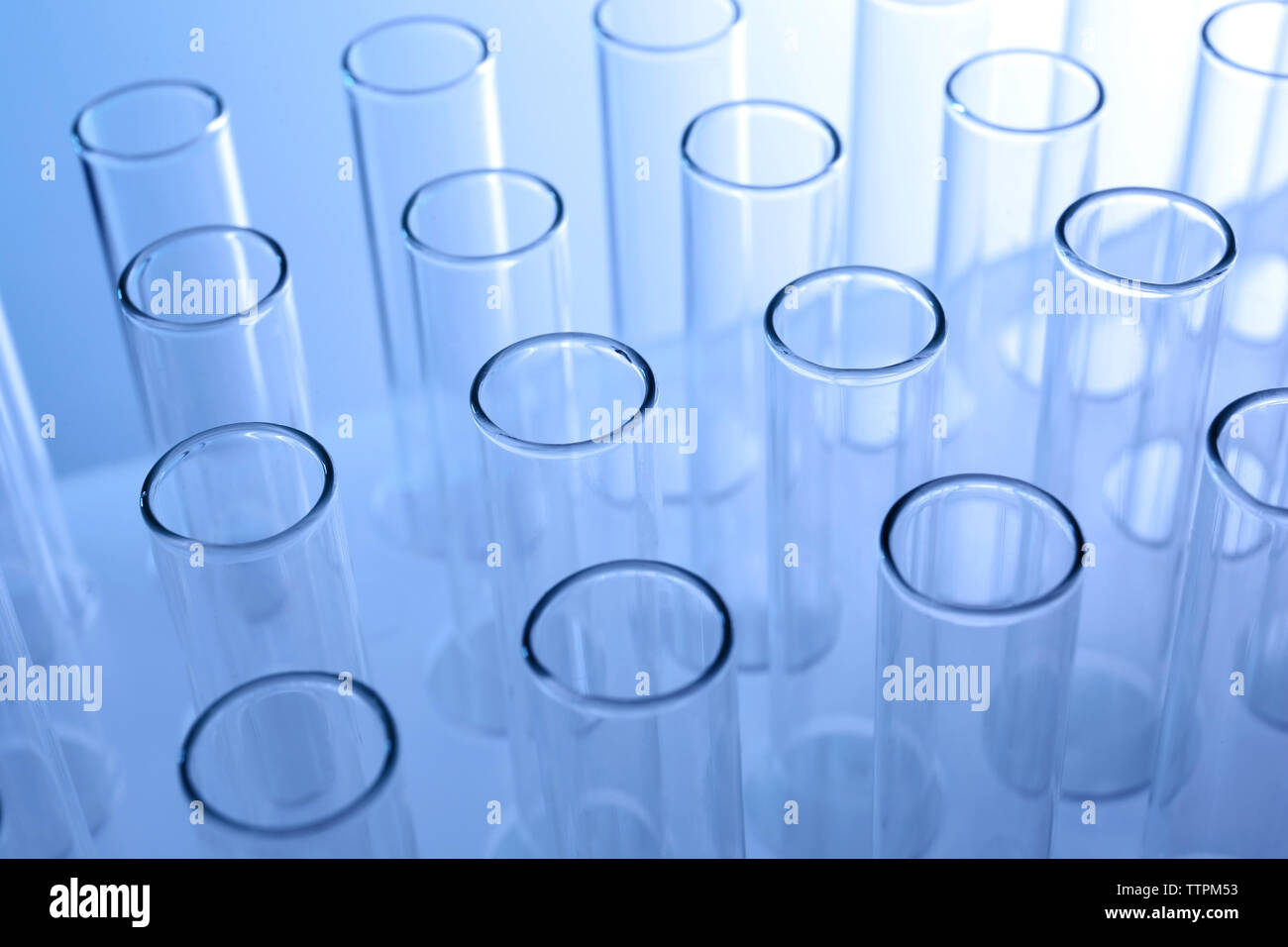 Test tubes on blue background Stock Photo - Alamy