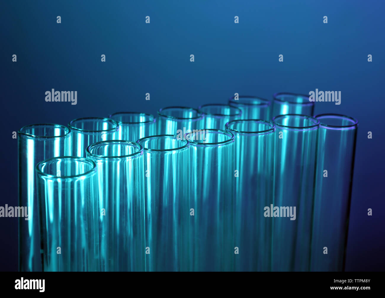Test tubes on blue background Stock Photo - Alamy