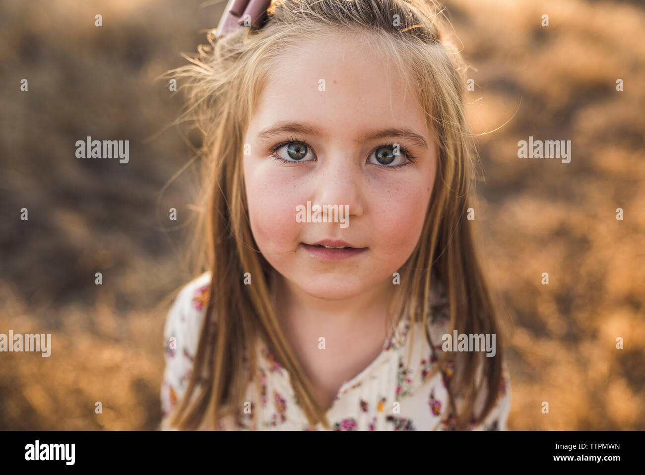 Close up portrait of young girl outdoors in California field Stock Photo