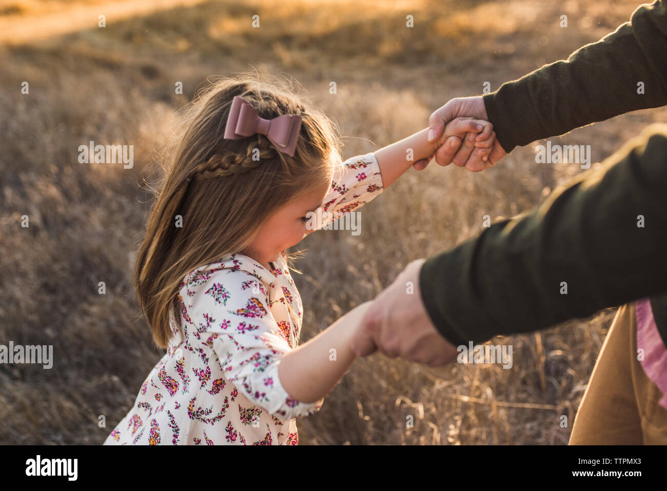 Close up of daughter dancing with father in California field Stock Photo