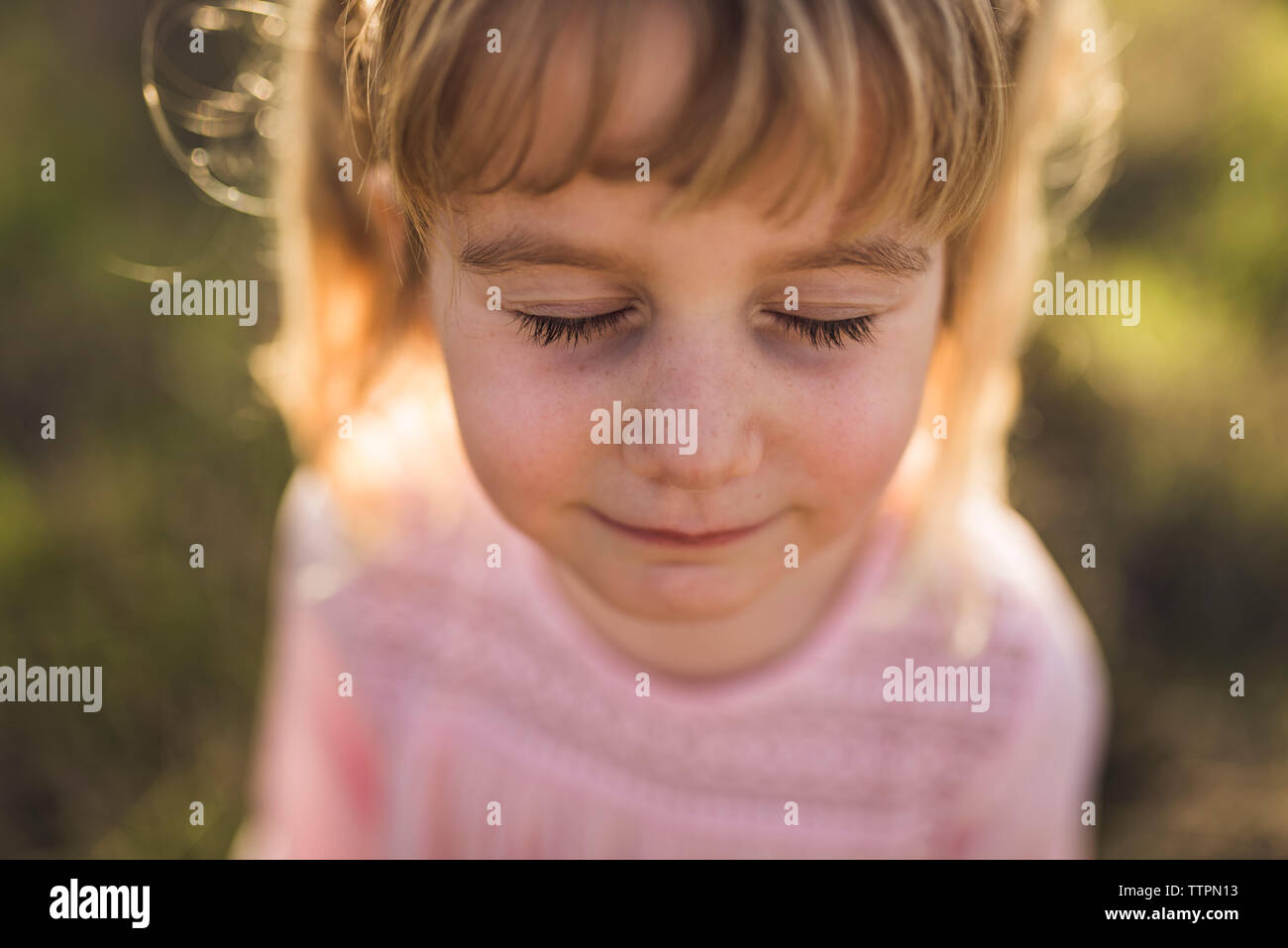 Close up portrait of young girl with eyes closed Stock Photo
