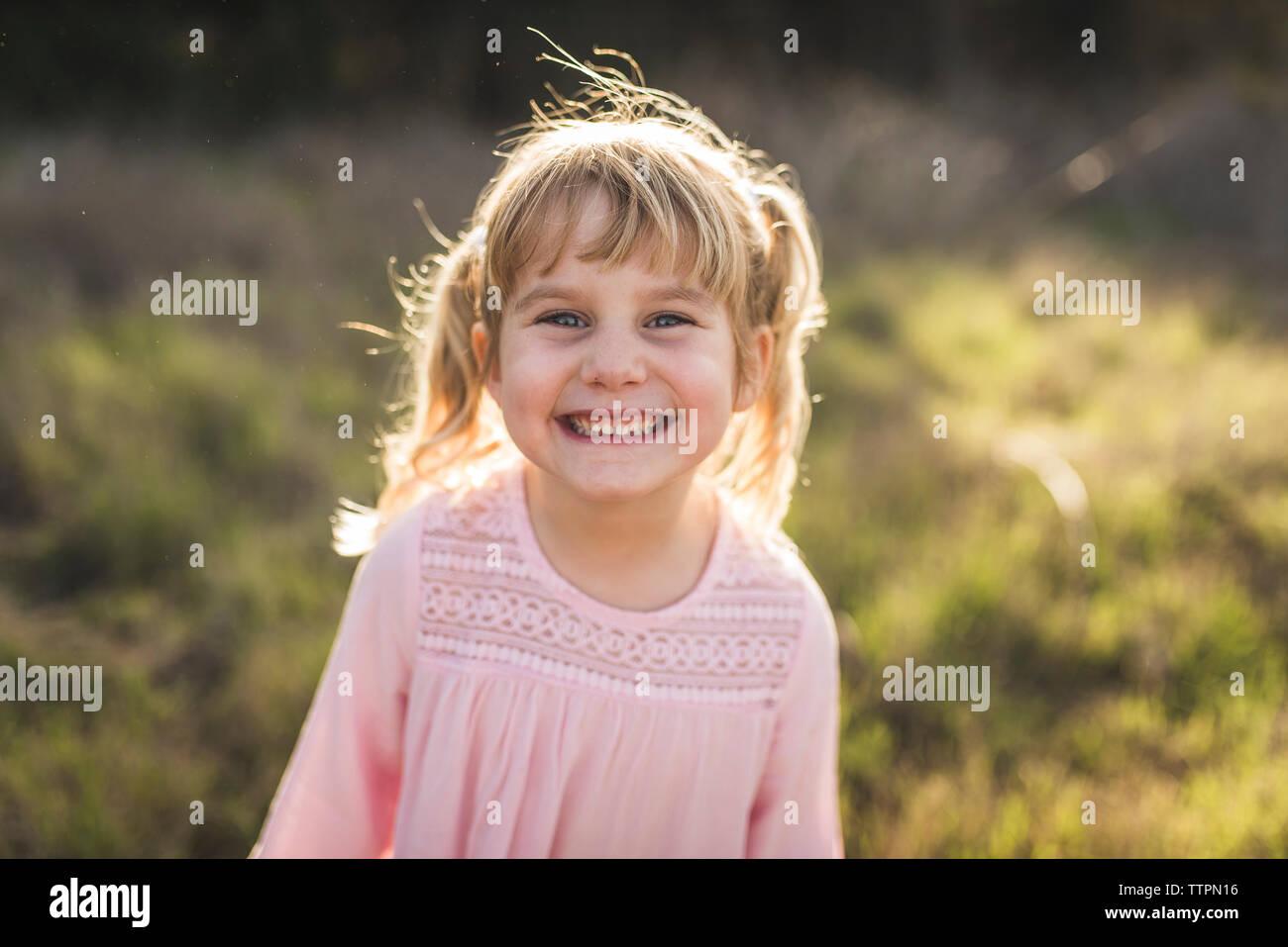 Portrait of young girl smiling at camera Stock Photo - Alamy
