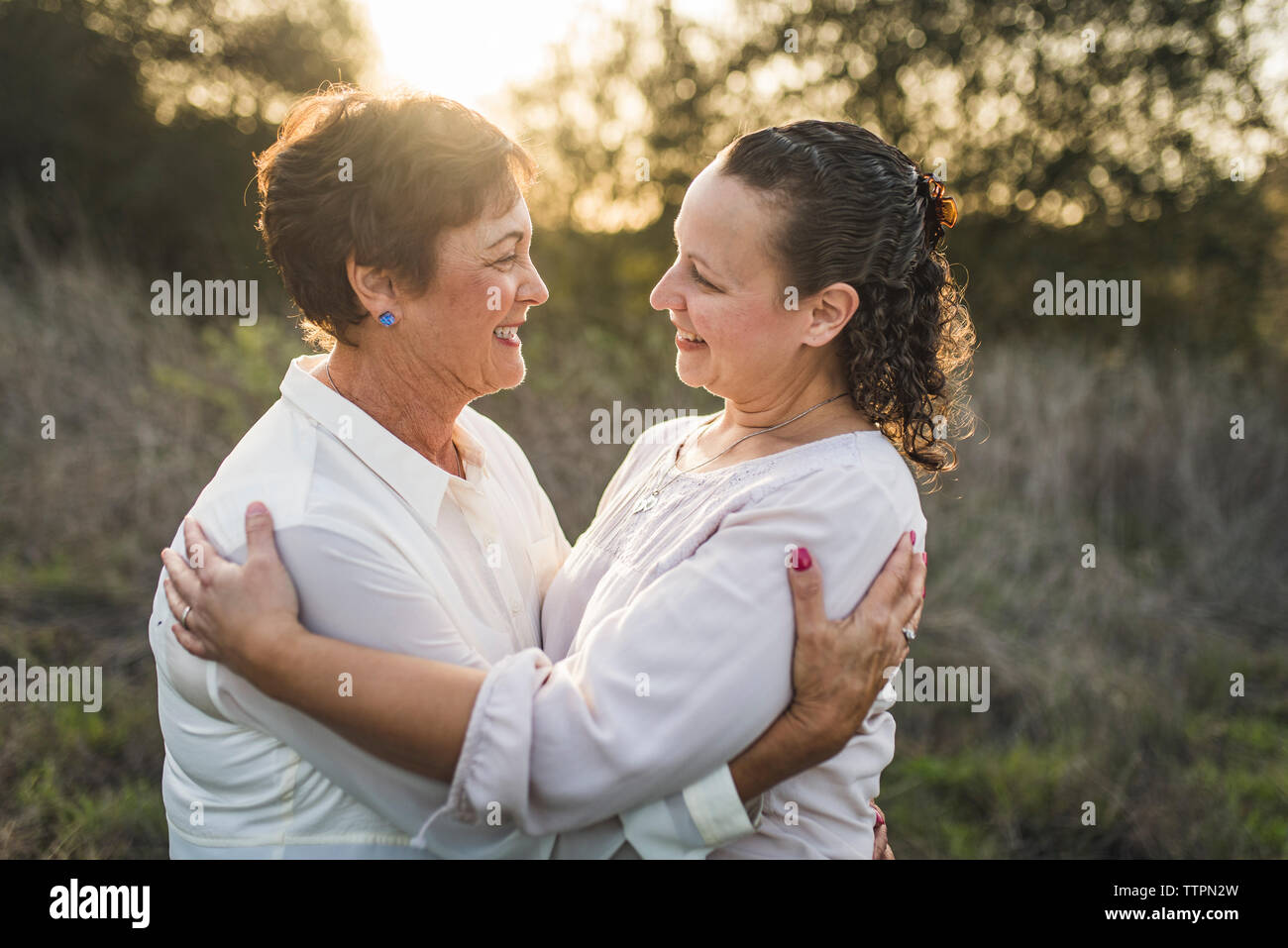 Close up portrait of adult mother and daughter embracing and smiling Stock Photo