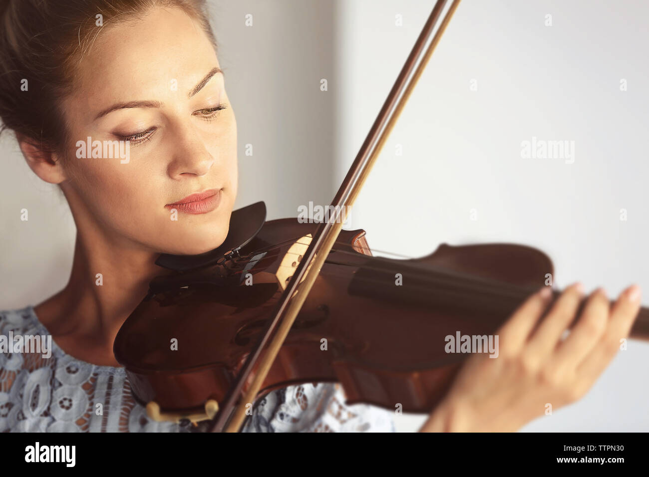 Beautiful woman playing violin Stock Photo