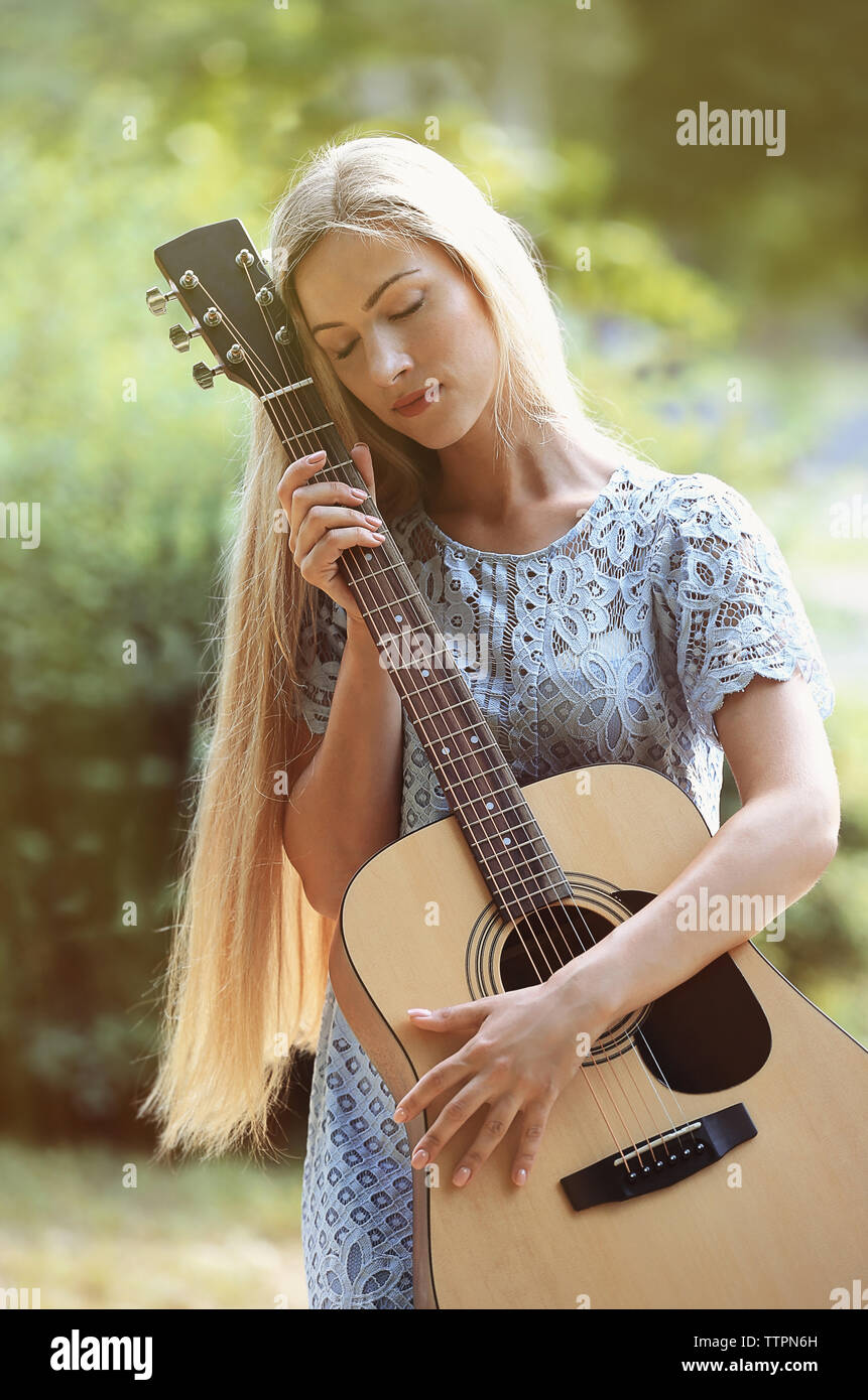 Beautiful woman with guitar Stock Photo - Alamy