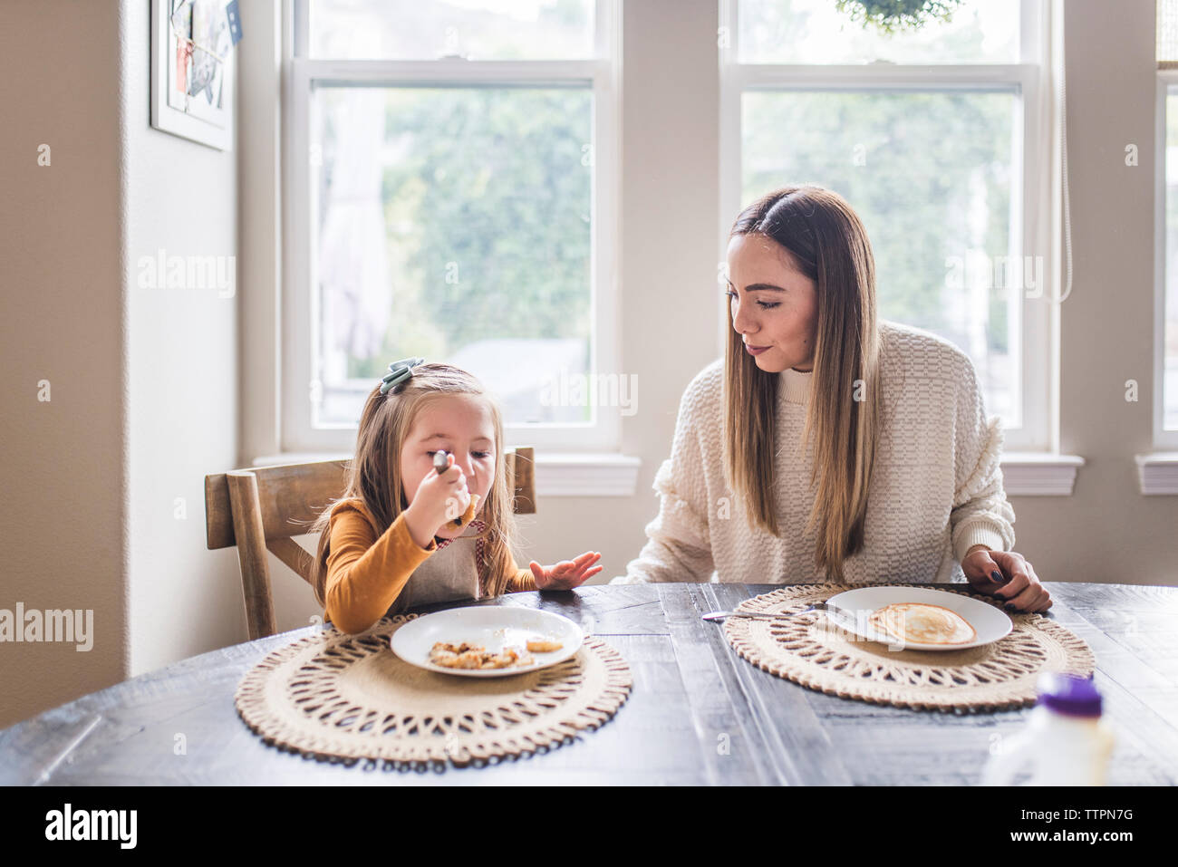 Multigenerational family eating pancakes for breakfast Stock Photo