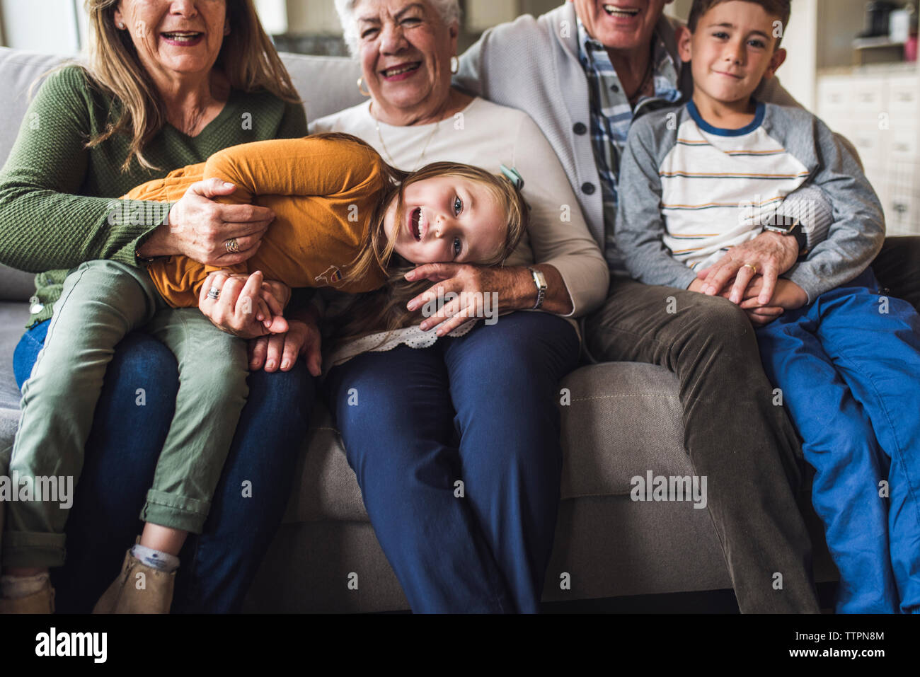 Close up of little girl laying on lap of great grandmother Stock Photo