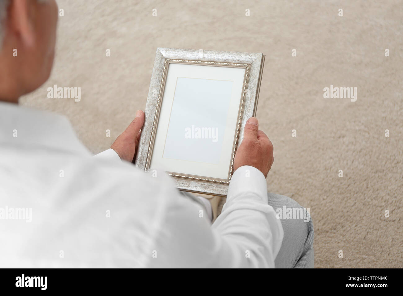 Man holding photo frame. Memories and nostalgia concept Stock Photo