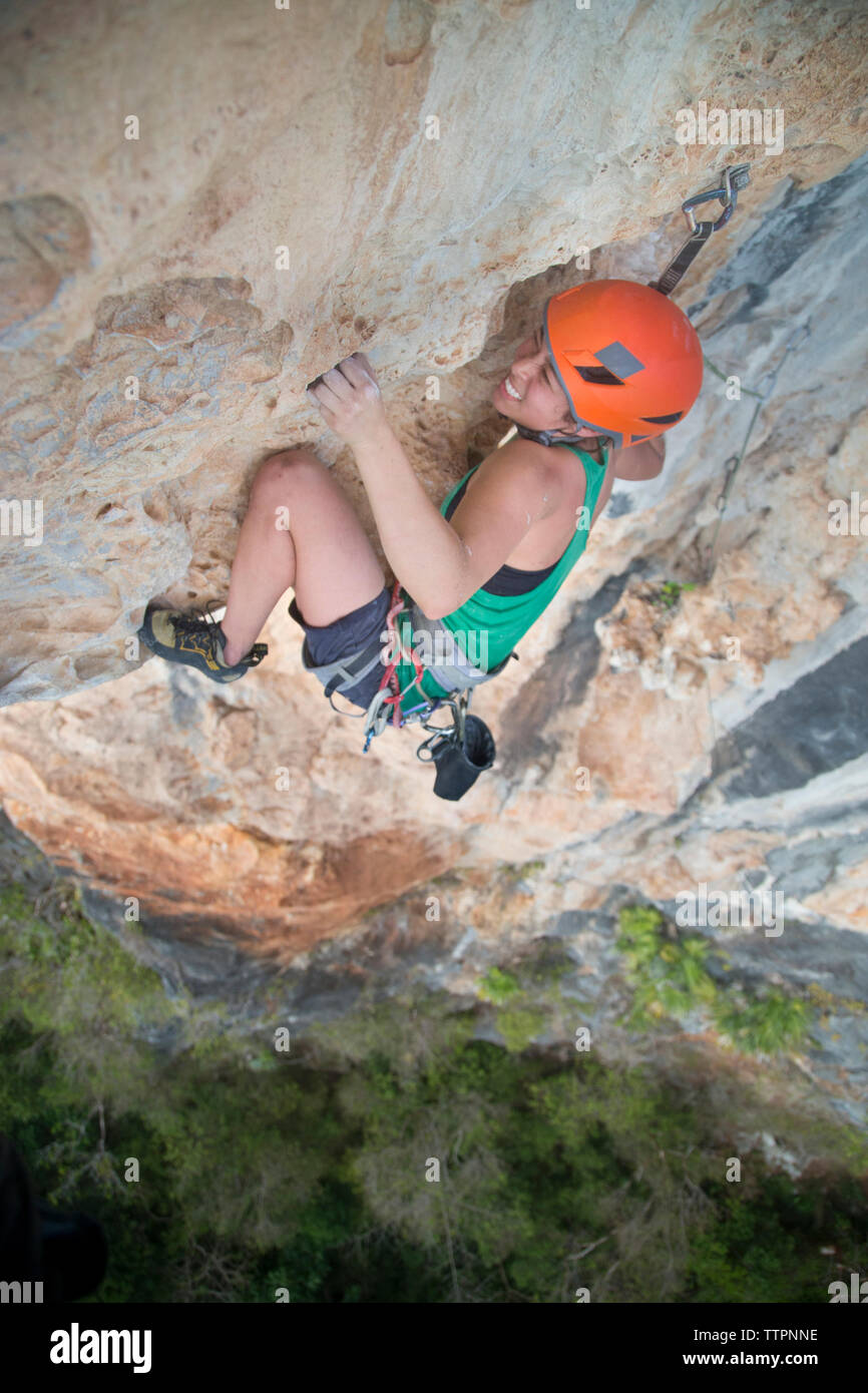 Full length of female hiker rock climbing Stock Photo