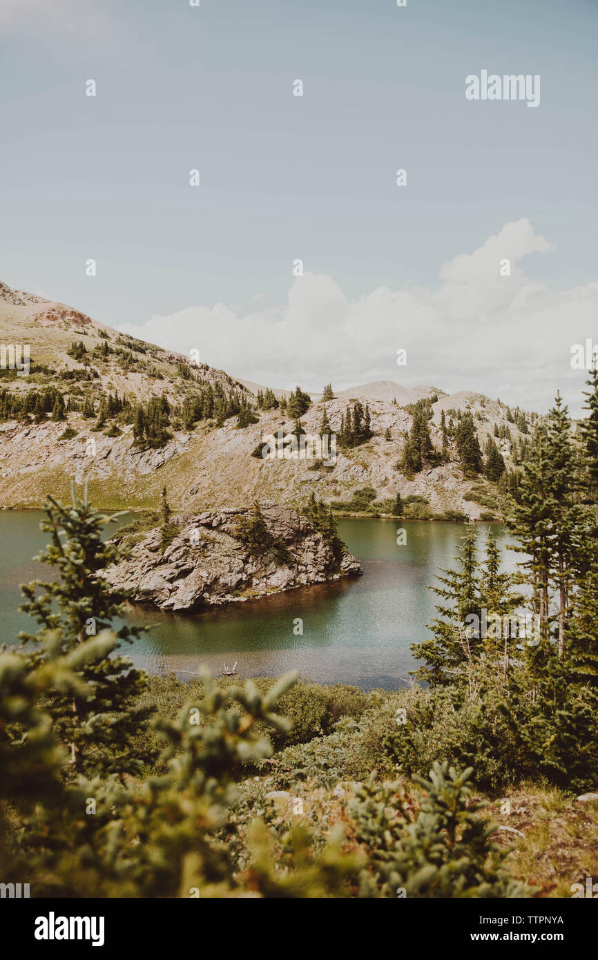 Idyllic view of lake by mountains against sky Stock Photo