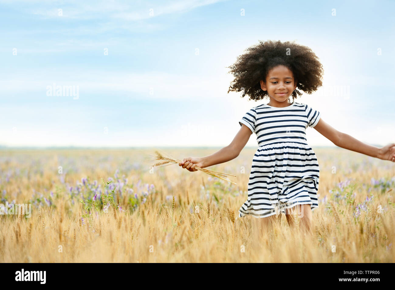 Happy little African American girl in the field Stock Photo - Alamy