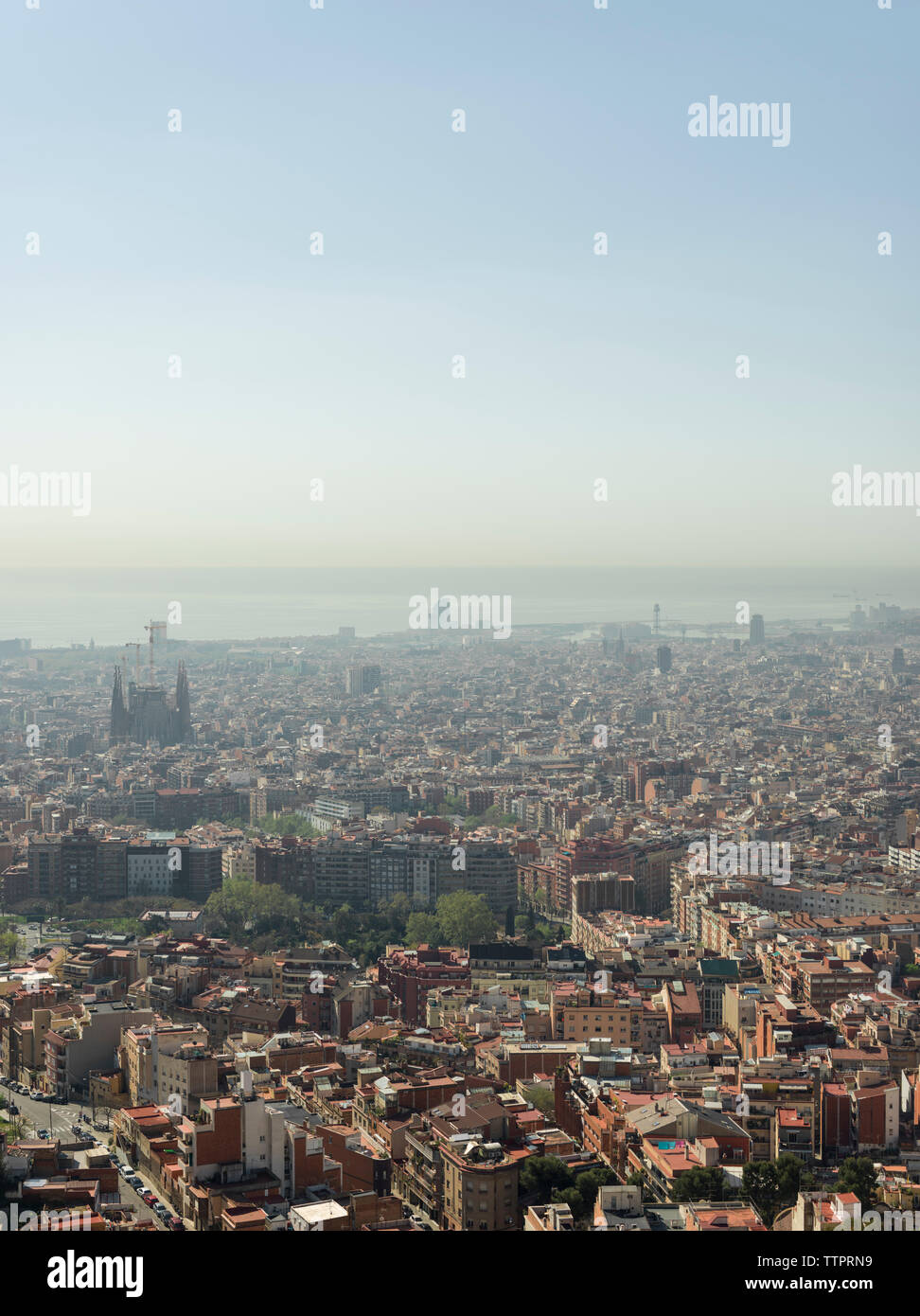 Aerial view of cityscape against clear blue sky during sunny day Stock ...