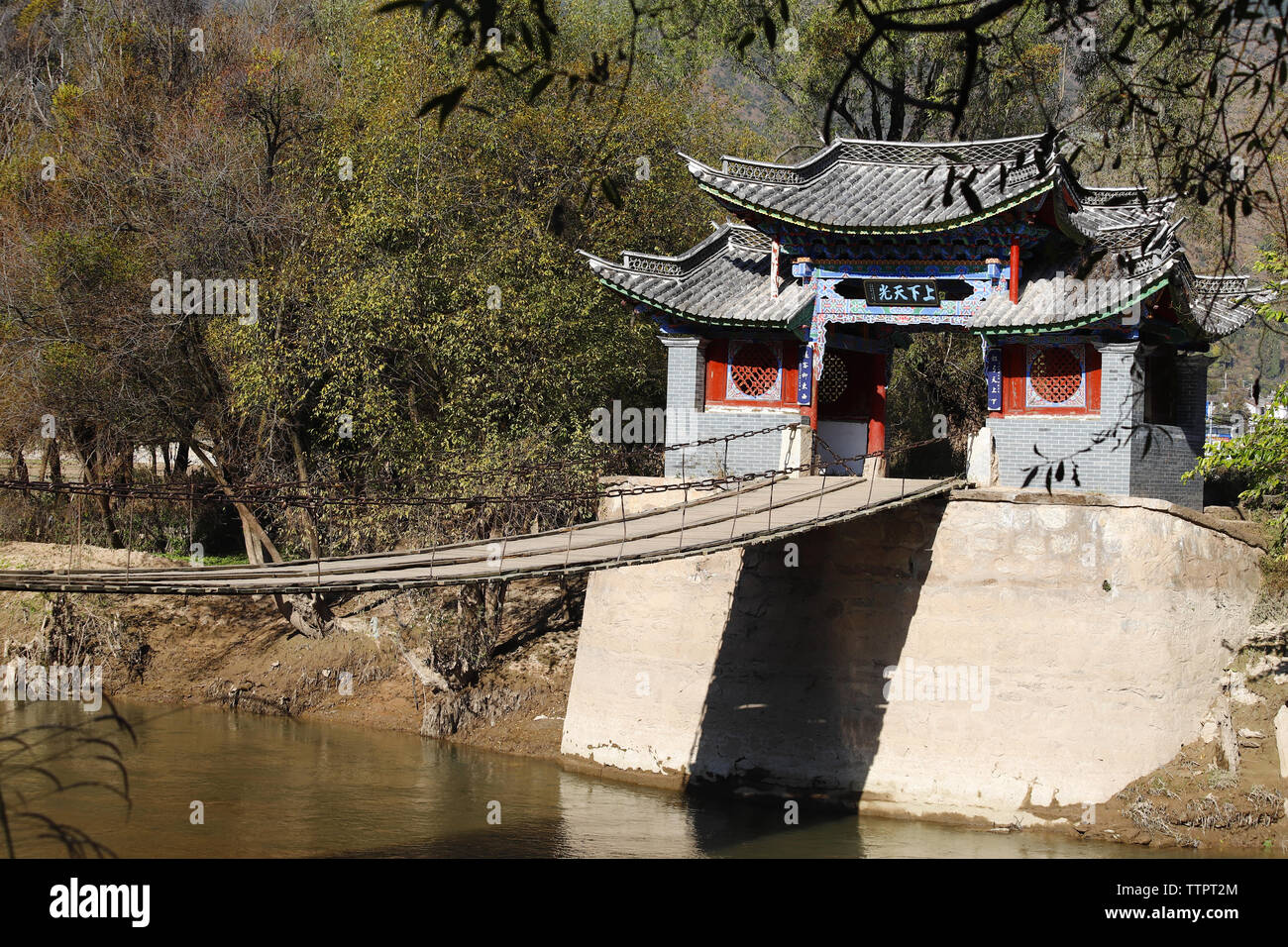 An ancient wooden suspension bridge along the ancient Southern Silk Road in  the village of Shigu in the province of Yunnan, China Stock Photo - Alamy